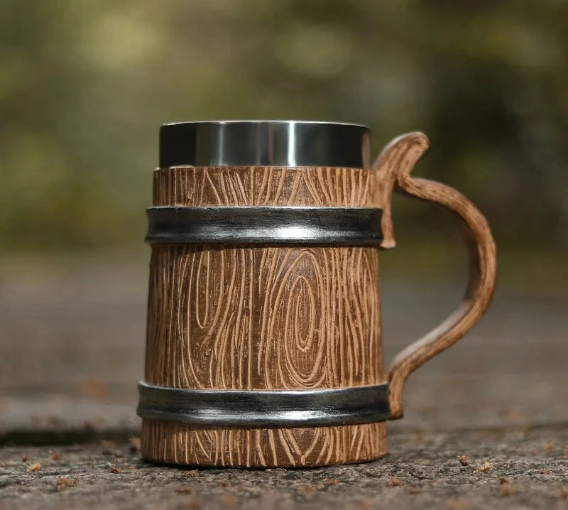 Wooden mug with metal band and handle on a natural background