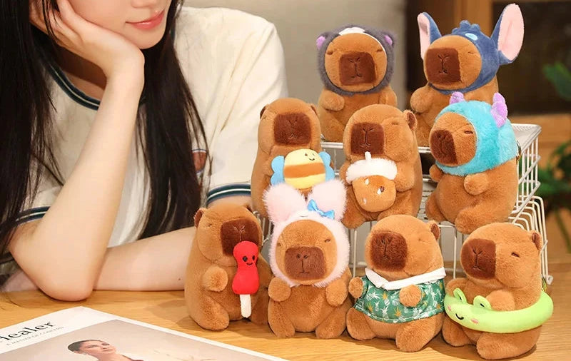 Woman sitting at a table with a collection of small plush toys resembling bears in various outfits.