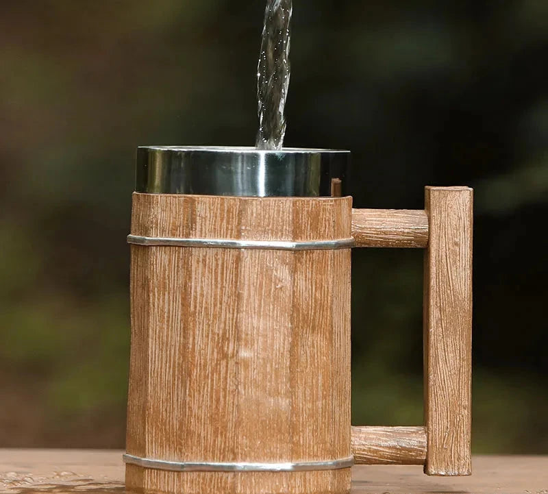 Wooden water faucet with water flowing against a blurred natural background