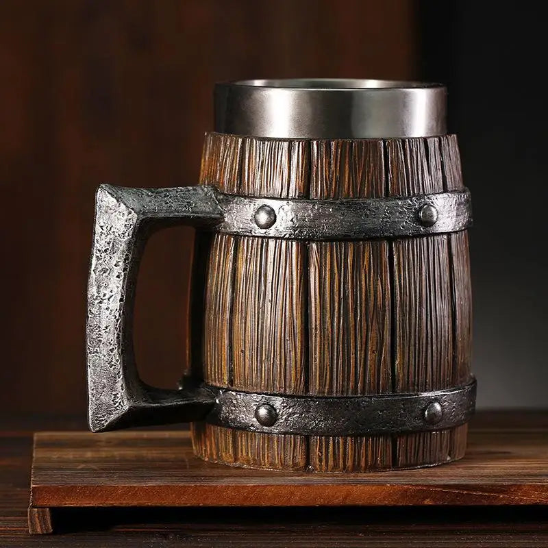 Wooden mug with metal handle and banding on a wooden surface