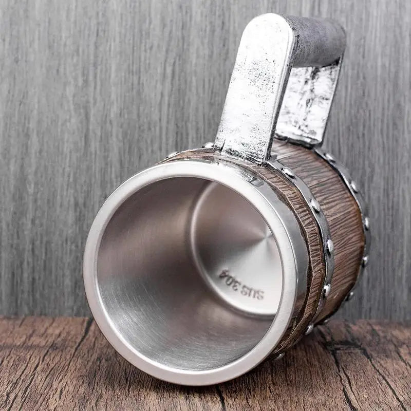 Metal cup holder with wooden rim on a wooden surface